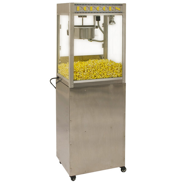 A Benchmark USA pedestal base with a popcorn machine on it filled with yellow popcorn.