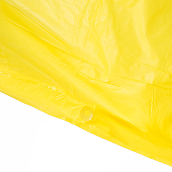 A yellow Cordova economy rain poncho in a clear plastic bag with a white background.