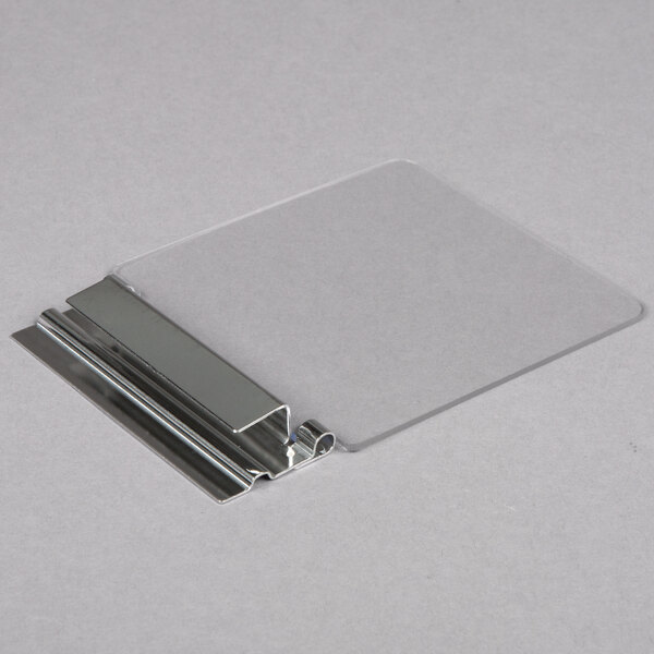 A clear plastic lid with a metal hinge.