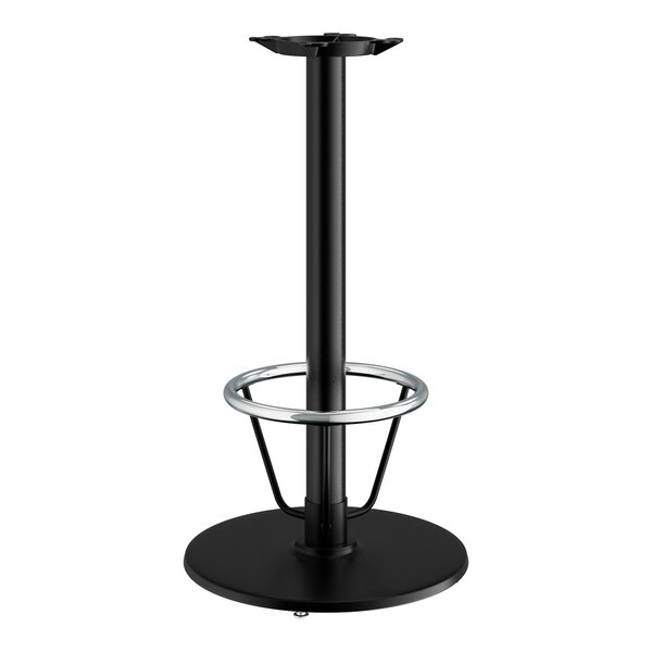 A Lancaster Table & Seating black cast iron bar height table base with a round foot ring.