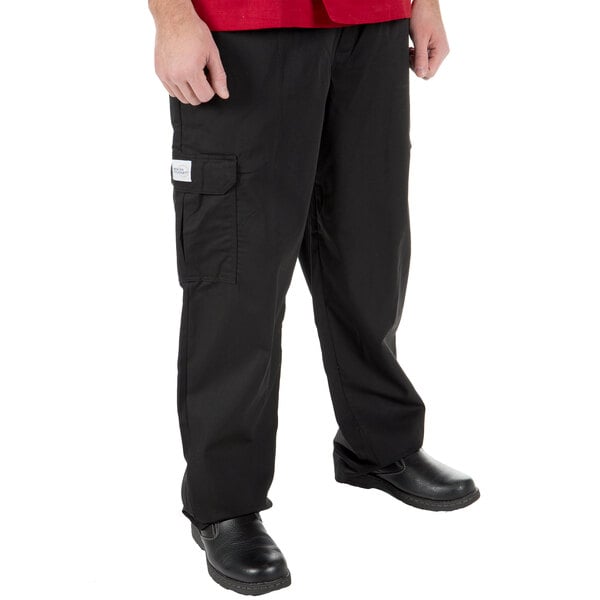 A man wearing Mercer Culinary Genesis black cargo pants.