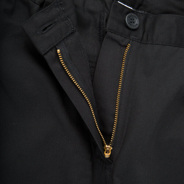A close up of the zipper on Mercer Culinary black chef trousers.
