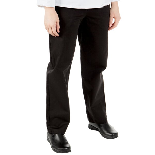 A woman wearing Mercer Culinary black chef pants.