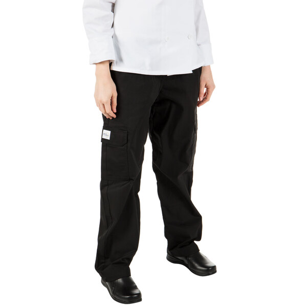 A young woman wearing Mercer Culinary Genesis black cargo pants.