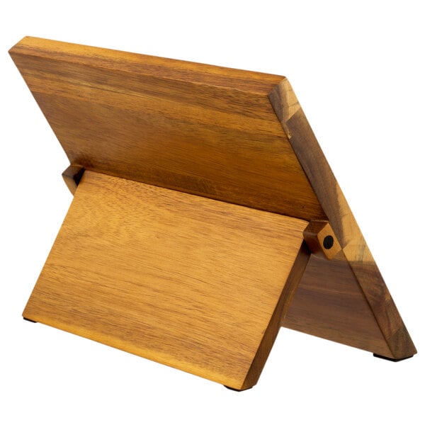 A Mercer Culinary Renaissance acacia wood knife board with knives on it.