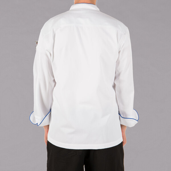 The back of a person wearing a Mercer Culinary white chef jacket with royal blue piping.