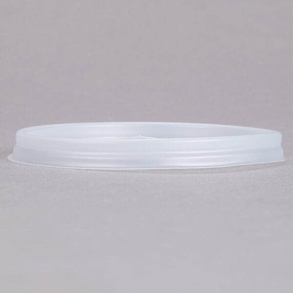 A white plastic lid with a straw slot on a white plastic container.