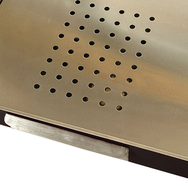 A metal tray with a hole in the middle and holes in the surface.
