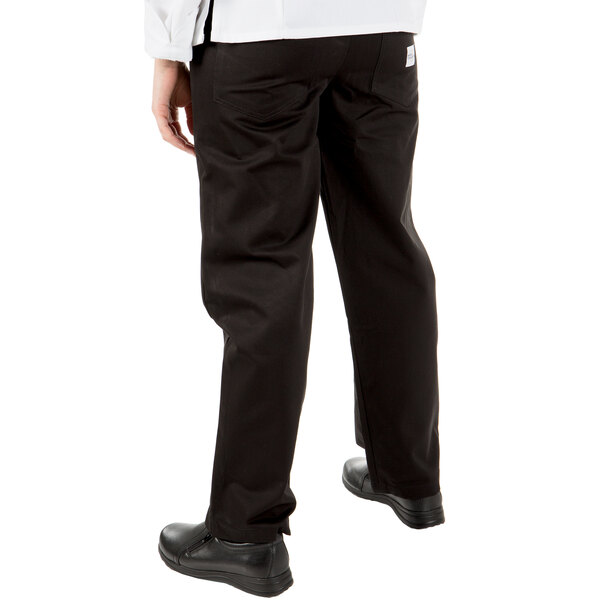 A person wearing Mercer Culinary black chef pants and a white shirt.