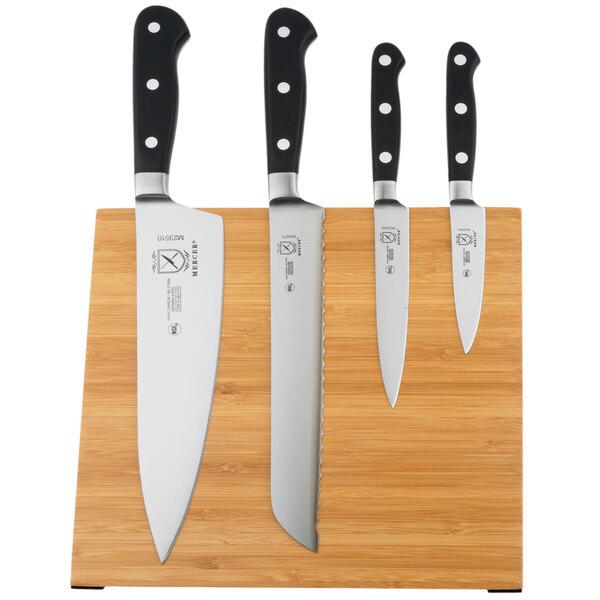 A group of Mercer Culinary Renaissance knives on a bamboo magnetic board.