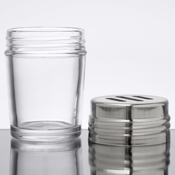 An American Metalcraft clear glass spice shaker with a stainless steel top and slotted holes.