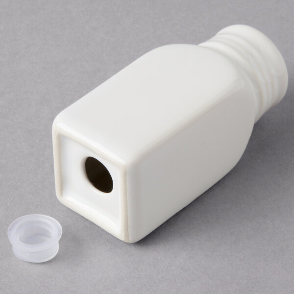 A white ceramic salt and pepper shaker set with a lid and plastic cap.