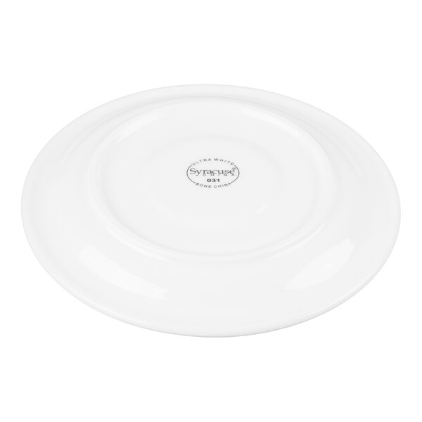 A white round saucer with a slightly raised rim and a logo printed in the center on the bottom side.