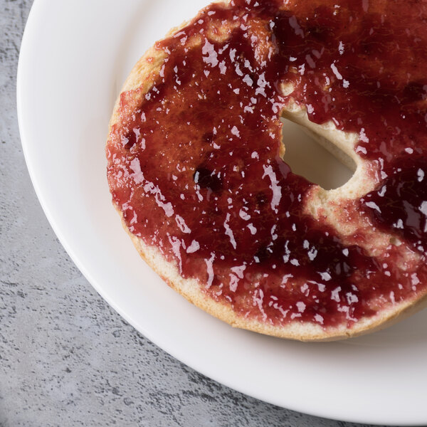 A bagel with jam on a Reserve by Libbey bone china side plate.