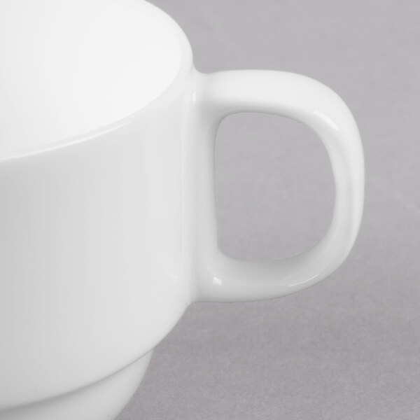A close-up of a white Libbey Reserve bone china cup with a handle.