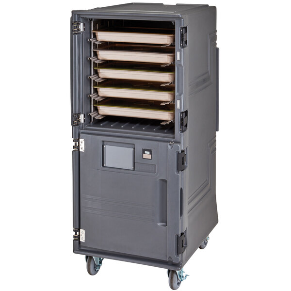 A large grey metal container with trays inside on wheels.