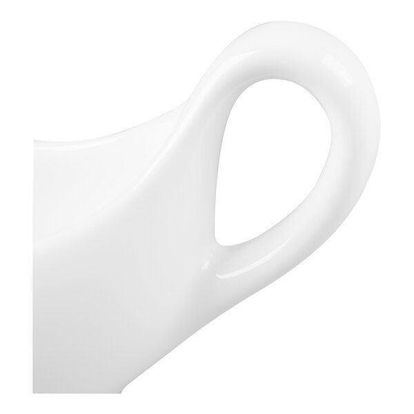 A close-up of a glossy white handle attached to a curved ceramic surface, likely part of a dish or vessel.