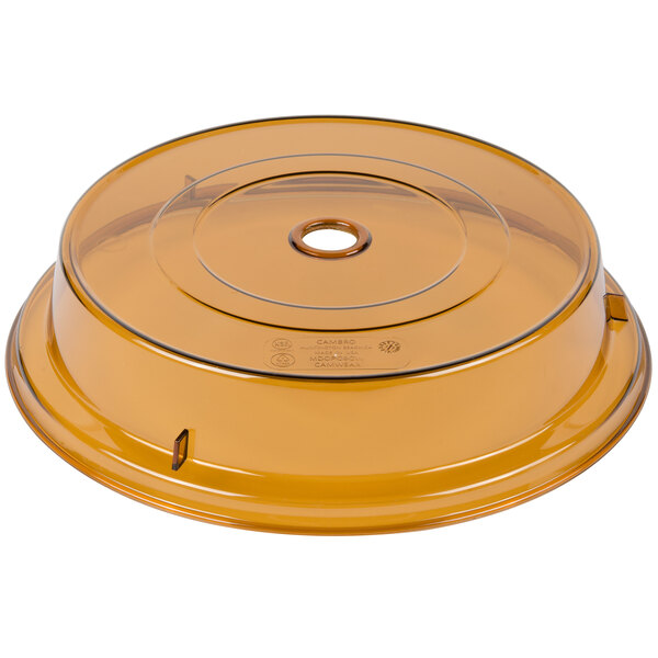 A yellow plastic Cambro Camcover with a hole in it.