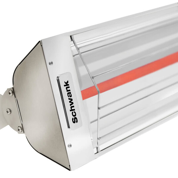 A close-up of a red and white light on a Schwank stainless steel outdoor patio heater.