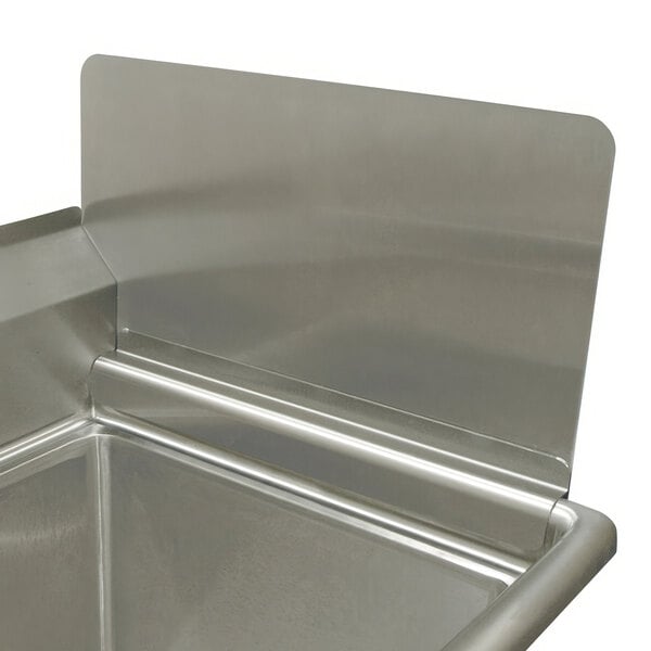 A close-up of a stainless steel removable side splash on a sink.