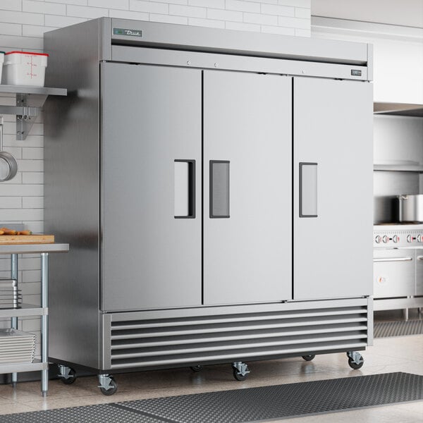 A True stainless steel reach-in freezer with a solid door.