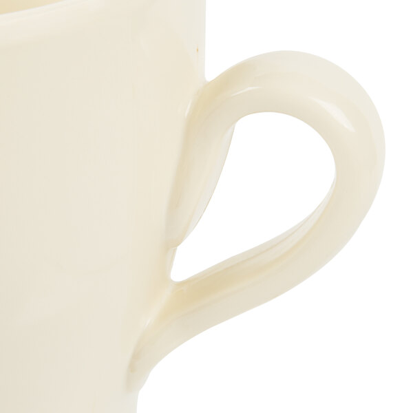 An Elite Global Solutions antique white melamine coffee mug with a handle.