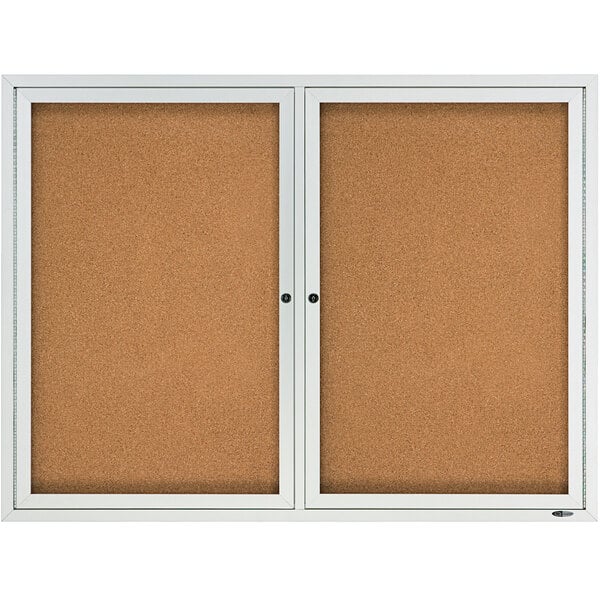 a cork board with a white frame