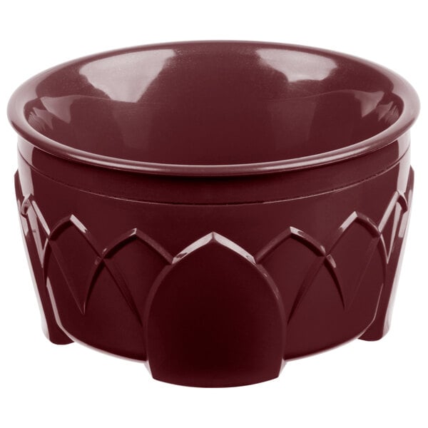 A red bowl with a carved design.