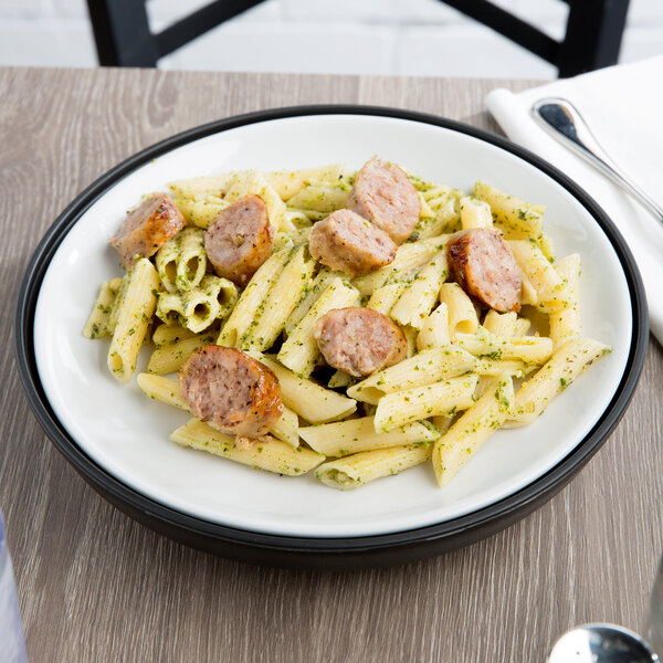A Dinex Onyx insulated meal delivery base with a plate of pasta, sausage, and pesto sauce.