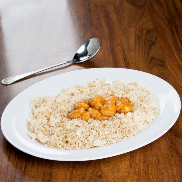 A Water Lily melamine platter with rice and meat on a table.