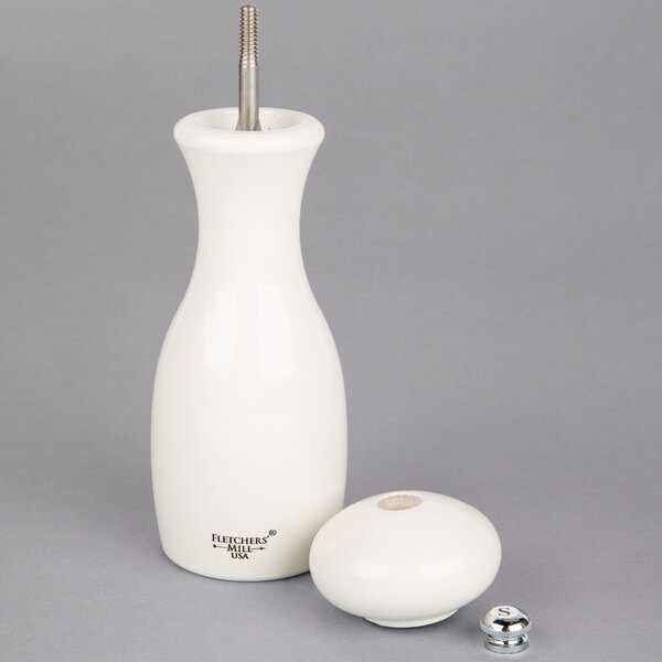 A white round object with a metal tube inside.