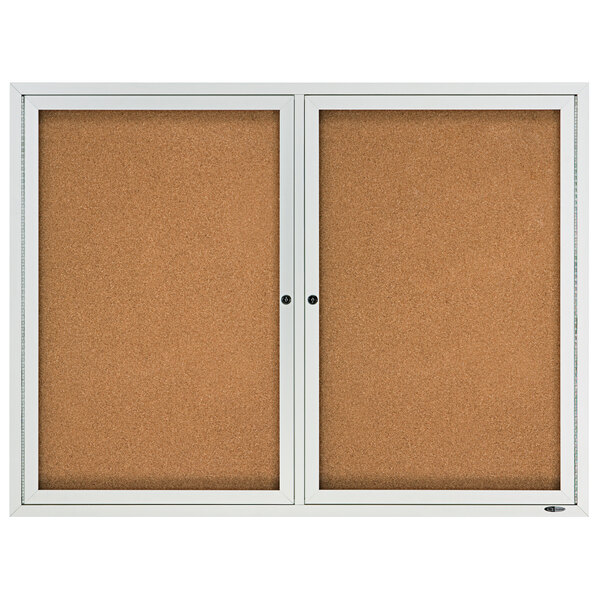 A silver aluminum enclosed Quartet cork bulletin board.