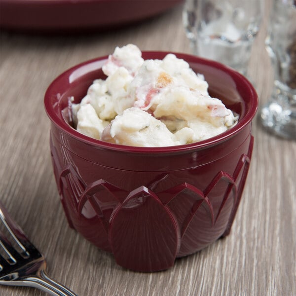 A bowl of food on a table with a fork and spoon.