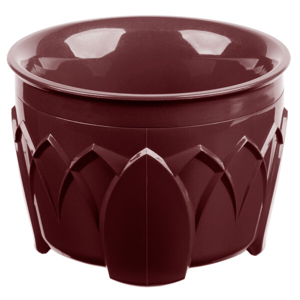 A red Dinex insulated bowl with a carved design.