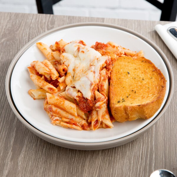 A white Dinex insulated meal delivery base with pasta and bread on it.