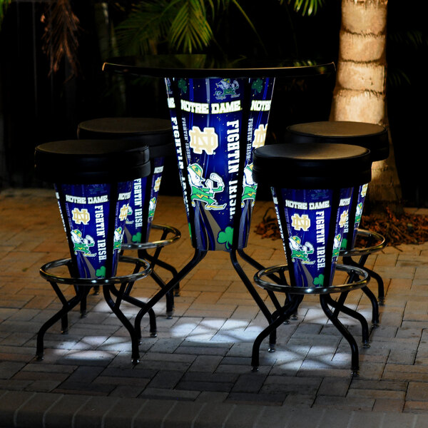 A University of Notre Dame pub table with a blue LED pole on a brick patio.