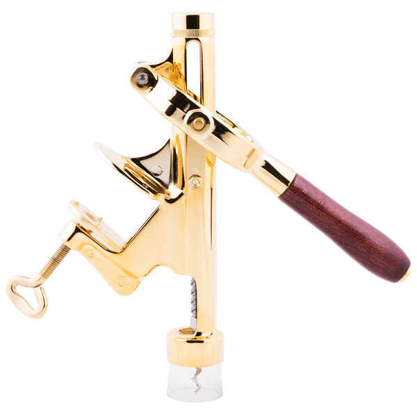 A gold and brown Franmara Cedon counter mount wine bottle opener.
