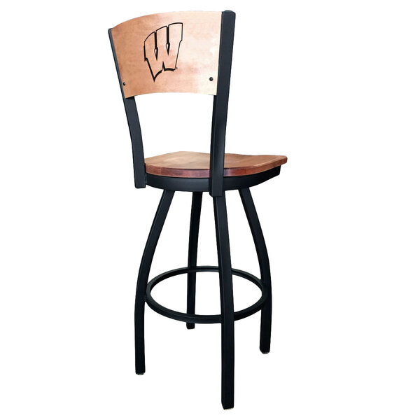 A black steel bar height swivel chair with a wooden seat and back engraved with the University of Wisconsin Badgers logo.