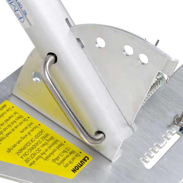 A metal pole with a yellow handle and a yellow label.