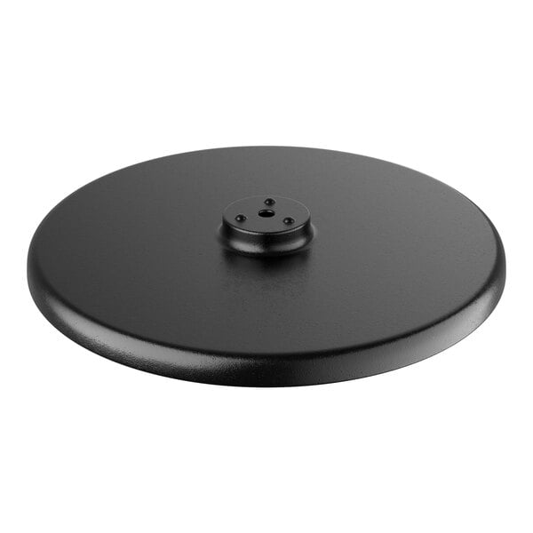 A black circular Lancaster Table & Seating cast iron table base plate with a hole in the center.