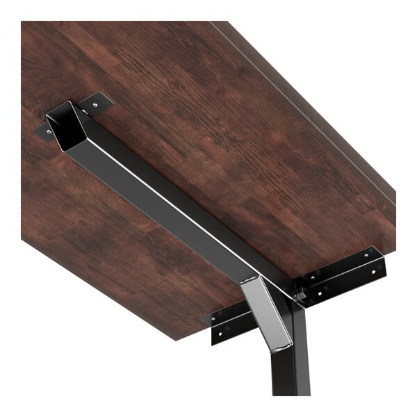 A Lancaster Table & Seating metal table bracket supporting a wooden table.