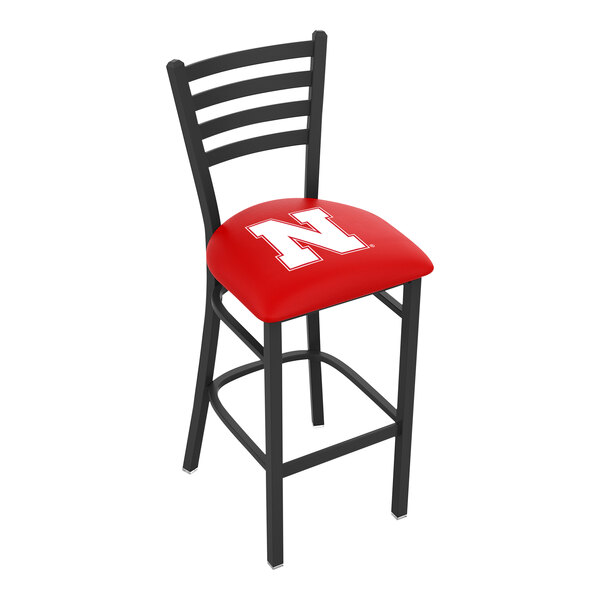 A black steel bar height chair with a ladder back and a red padded seat featuring a white 'N' logo.