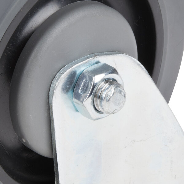 A close-up of a Garland and US Range swivel plate caster wheel with a bolt.