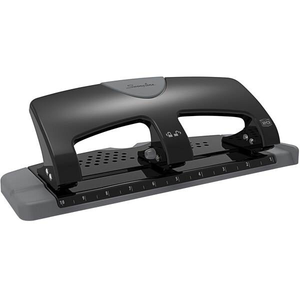 A black and gray Swingline 3 hole punch on a white surface.