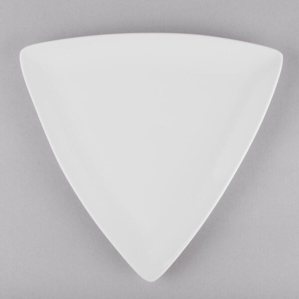 A close up of a white Libbey Porcelana triangle shaped plate.