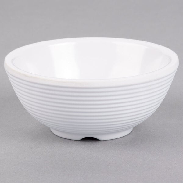 A white Tablecraft ramekin on a gray surface.