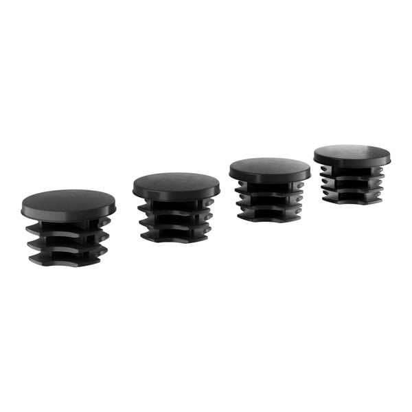 A set of four black plastic round post caps.