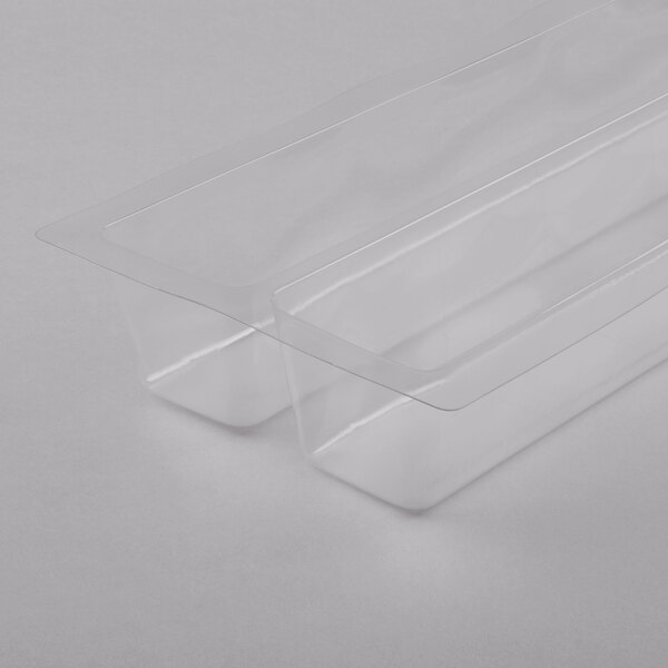 A clear plastic container with a thin strip and a clear lid holding two Matfer Bourgeat PVC plastic cake molds.