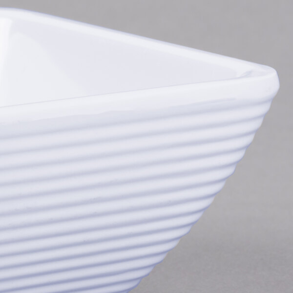 A Tablecraft white square ribbed melamine ramekin.