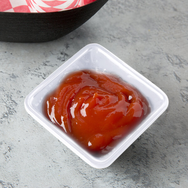 a plastic container of ketchup